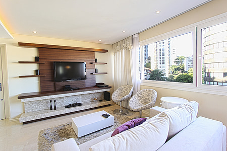 black flat screen TV on brown wooden entertainment rack thumbnail