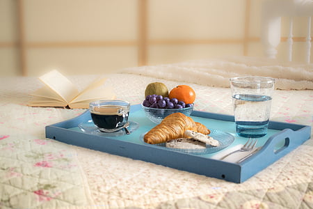 assorted fruits, two clear drinking glasses with liquids, and pie on blue wooden tray thumbnail