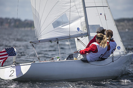 shallow focus photography of three people riding sailboats thumbnail