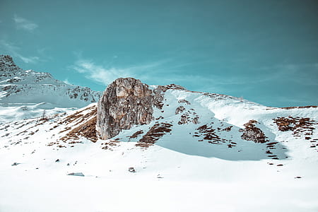mountains under snow during daytime thumbnail