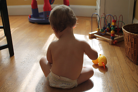 baby sitting on the floor while playing toy thumbnail