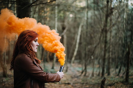 woman holding colored smoke tube thumbnail
