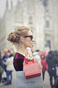 Woman Wearing Red Top Carrying Red Paper Tote Bag thumbnail