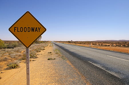 empty asphalt road way with floodway road sign at daytime thumbnail