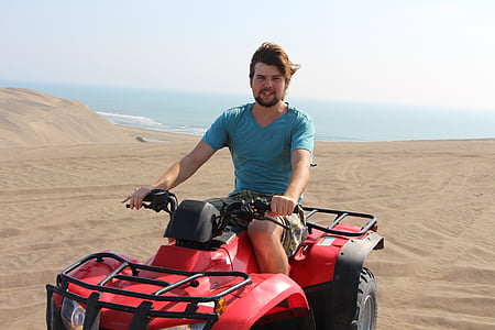 man riding ATV on desert thumbnail