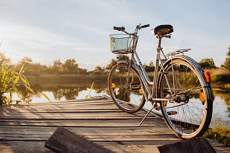 Bicycle with basket on the pier in bright sunset light thumbnail