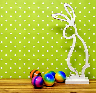 five assorted-color ornaments beside white rabbit wooden decor thumbnail