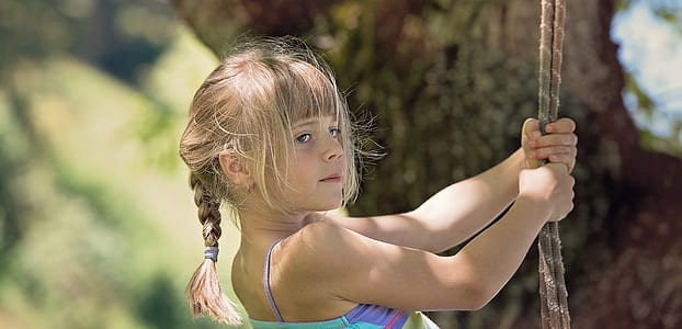 girl holding ropes near tree thumbnail