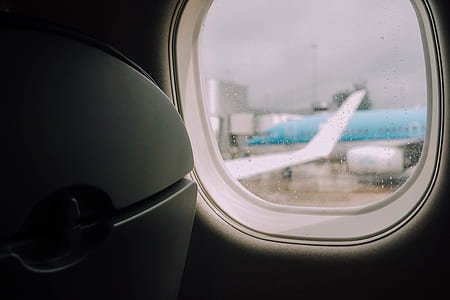 blue and white airplane through airplane's window thumbnail