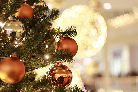 tilt shift lens view of brown baubles on Christmas Tree with lights thumbnail