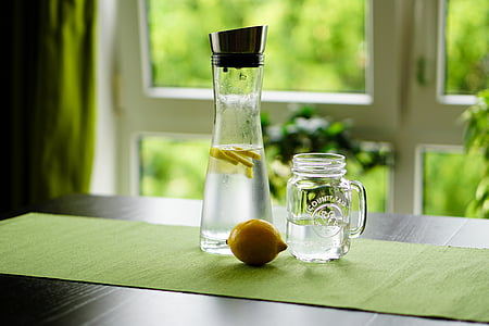 shallow focus photography of sliced lemon in glass bottle with water thumbnail