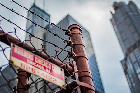 low-angle selective focus photography of barbed wire fence thumbnail