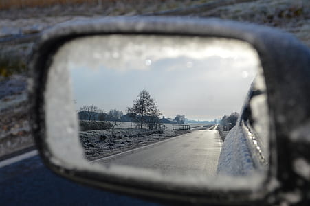 view of empty paved road at daytime from vehicle side mirror thumbnail