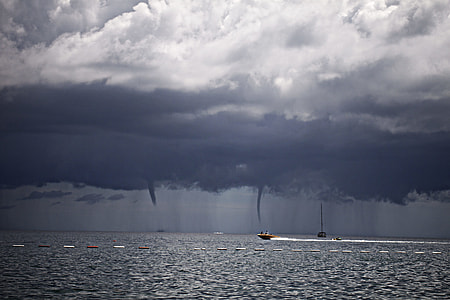 photography of boat under cloudy sky thumbnail