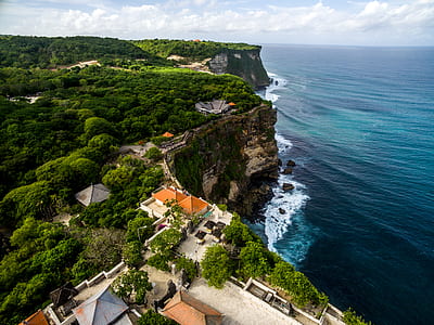 aerial photo of houses near sea and trees thumbnail