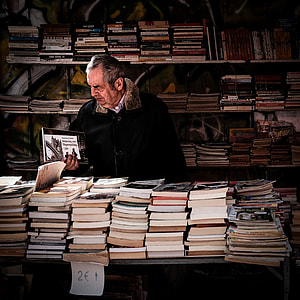 man holding book inside library thumbnail