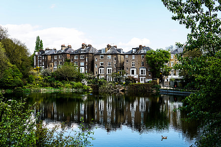 brown concrete buildings beside body of water during daytime thumbnail