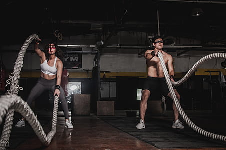 Man And Woman Holding Battle Ropes thumbnail