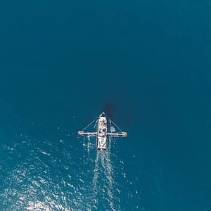 white boat on body of water at daytime top view photography thumbnail