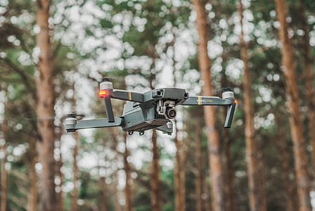 gray quadcopter flying in mid air thumbnail