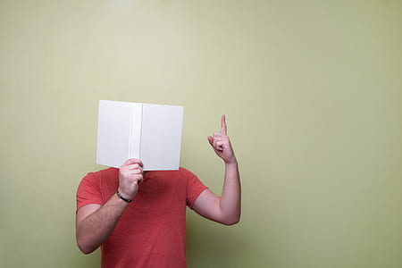 man in red crew-neck top holding paper thumbnail