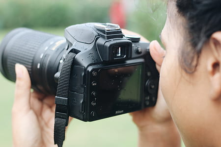 person using DSLR camera thumbnail