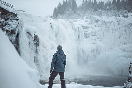 man standing near on waterfalls thumbnail