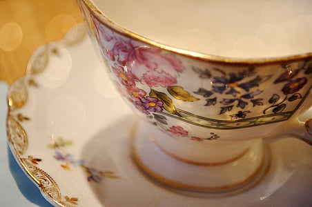 white and multicolored floral ceramic tea cup on white ceramic saucer thumbnail