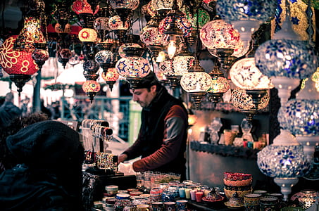 man wearing red and black jacket surrounded mosaic pendant lamps thumbnail