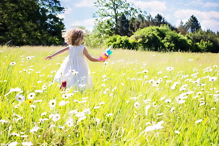 girl running in white flower field thumbnail