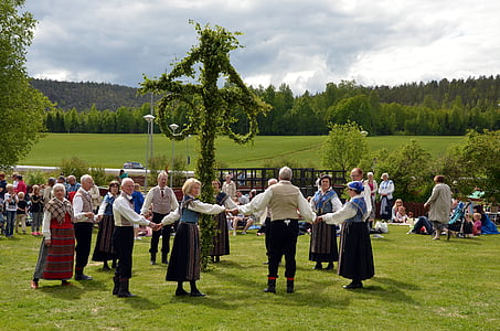 people holding hands around green topiary thumbnail