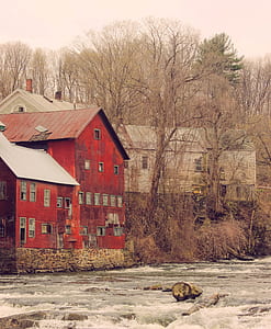 orange and gray houses near body of water thumbnail