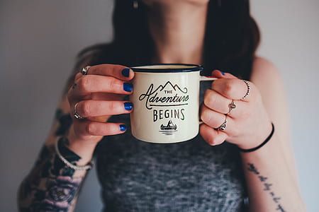 person holding white ceramic coffee mug thumbnail