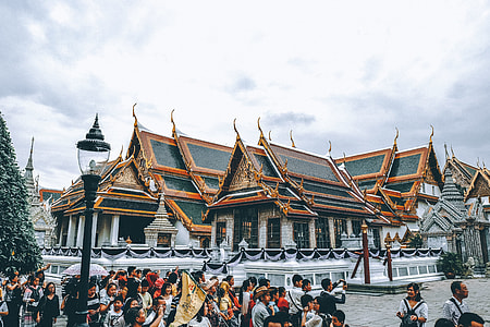 group of people standing beside temple thumbnail