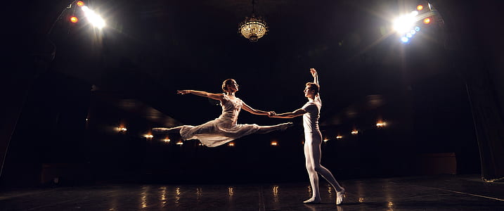 man and woman on black stage thumbnail