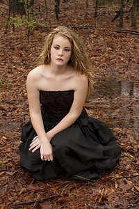 photo of woman in black strapless long dress sitting on floor thumbnail