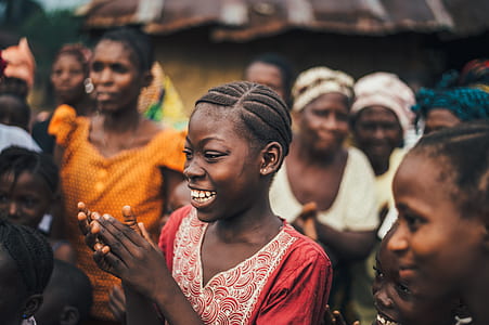 selective focus photo of woman happily smiling with hands clasp thumbnail