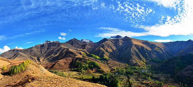 landscape photography of mountain range under cirrus clouds thumbnail