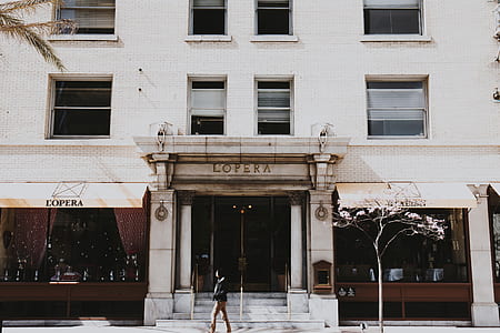 person walking in front of building thumbnail