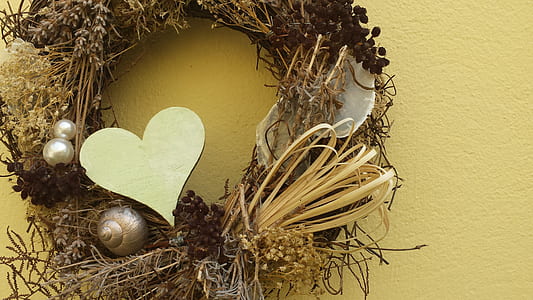 brown and gold heart wreath on yellow wall thumbnail