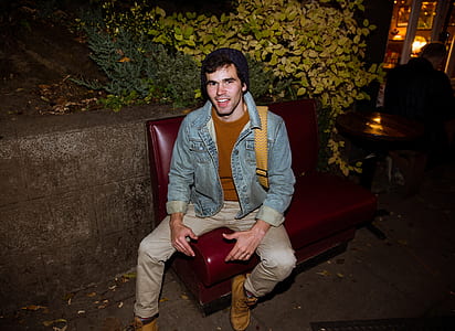 man sitting on leather bench thumbnail