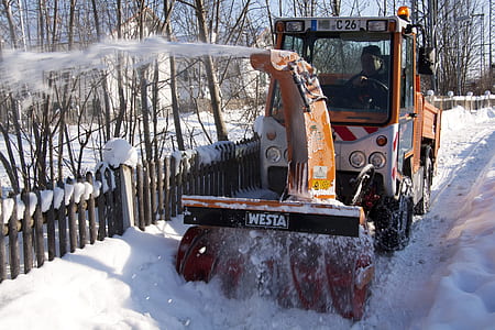 yellow truck with snow plow during daytime thumbnail