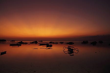 silhouette of boat on body of water thumbnail