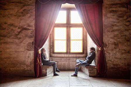 photo of man and woman sitting on terrace beside a window thumbnail