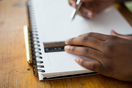 person holding ruler and drafting pen thumbnail