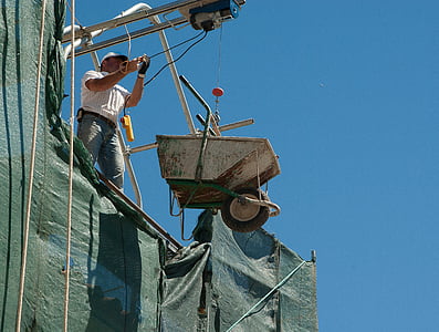 man holding cable to drop down wheelbarrow thumbnail