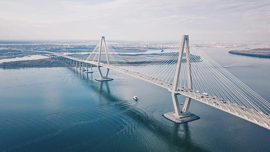 suspension bridge with cars during daytime thumbnail