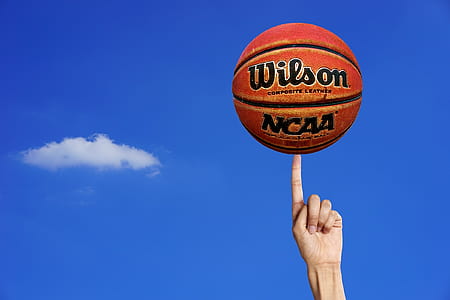 Wilson NCAA ball on left person index finger thumbnail