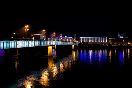 lighted bridge above body of water thumbnail