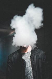 man blowing smoke wearing black zip-up jacket thumbnail